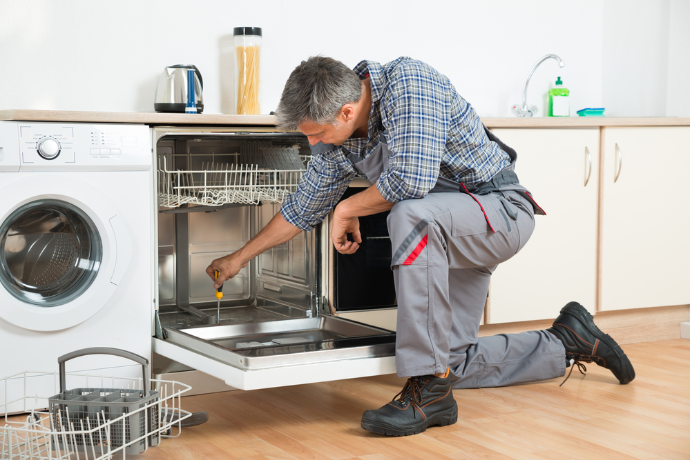 AT Appliance Repair technician working on a home appliance